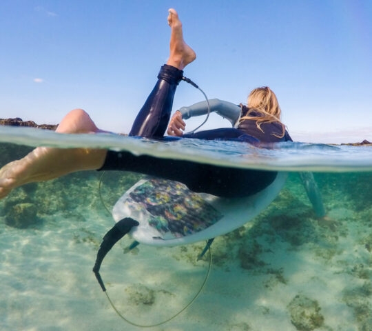 Woman surfing in Indonesia