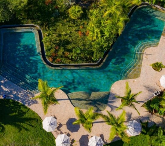 Aerial view of an outdoor swimming pool surrounded by jungle at Nantipa in Costa Rica