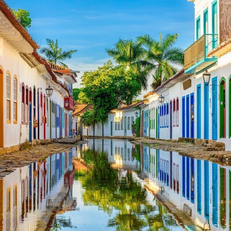 historic buildings reflected in a flooded street in Paraty, Brazil, during a family trip.