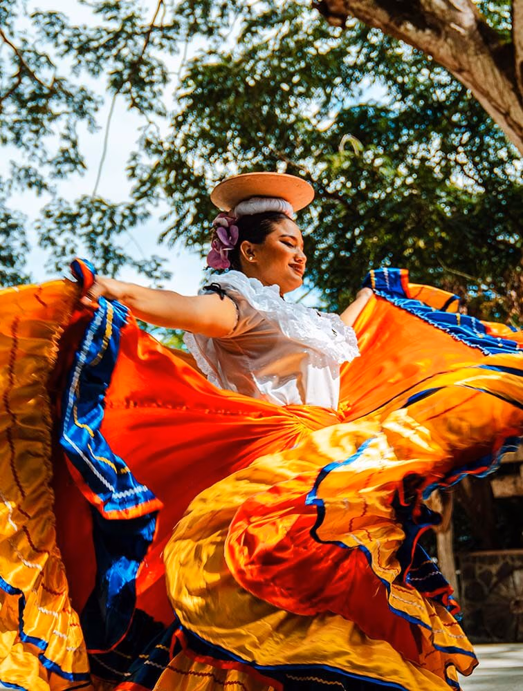 A traditional Guanacaste dancer in Costa Rica twirls beautiful vibrant clothing.