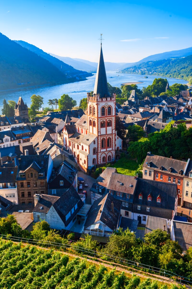 High-angle view of St. Peter's Church and historic buildings along the Rhine River in Bacharach, Germany.