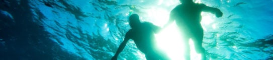 Senior couple snorkelling in tropical sea