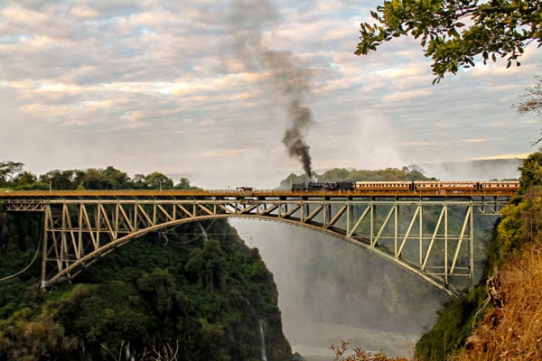 A steam train going over a bridge at Victoria Falls, Zimbabwe