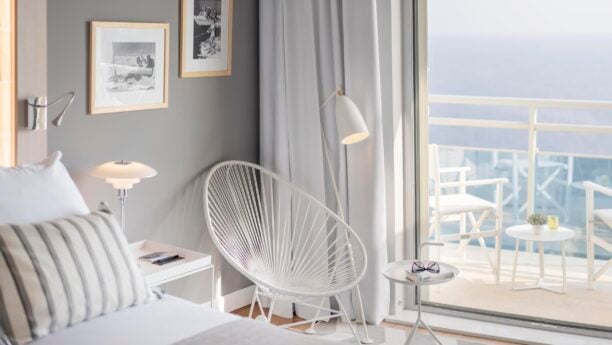 Bedroom area with chairs overlooking the ocean in Croatia Hotel Bellevue Dubrovnik