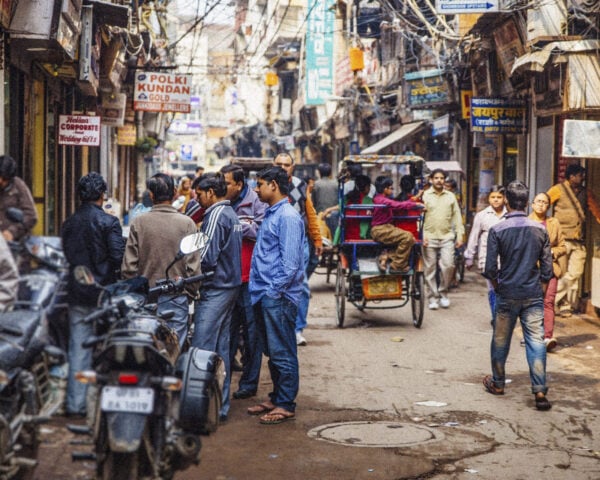 Old Delhi rickshaws are seen scattered down a busy Dehli street