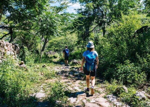 Two hikers on the ancient stone paved road from Barichara to Guane called 