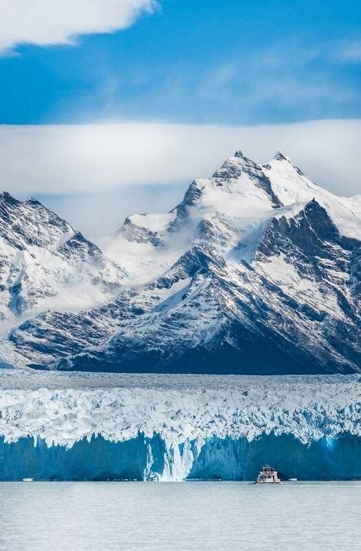 A tour boat passes by in front of the massive Perito Moreno Glacier at El Calafate, Argentina