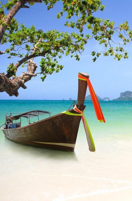 Tropical beach in Thailand and traditional long tail boat