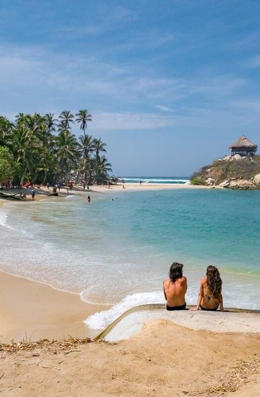 A couple sitting by the sea in Colombia, Tayrona