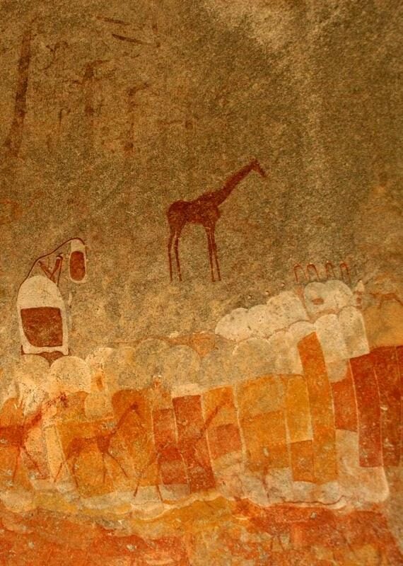 Ancient rock painting of human figures and antelopes, giraffe in Zimbabwe