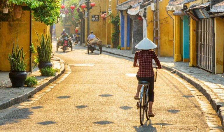 Woman cycling in Hoi An in Vietnam