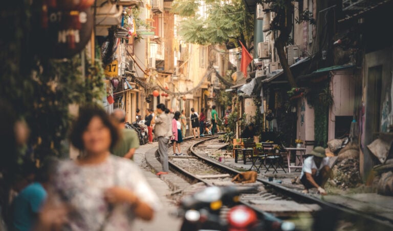 A street with train tracks running through in Hanoi, Vietnam