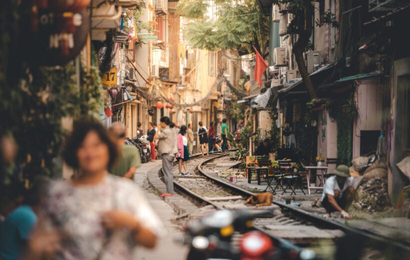 A street with train tracks running through in Hanoi, Vietnam