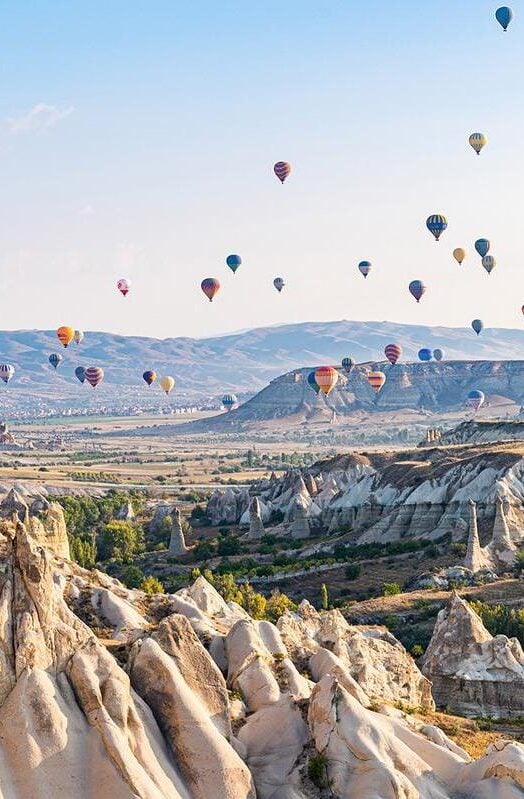 Göreme Historical National Park, Turkey with hundreds of brightly colored balloons