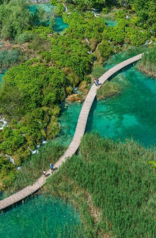 Aerial view of a wooden boardwalk leading through plitvice lakes national park in Croatia