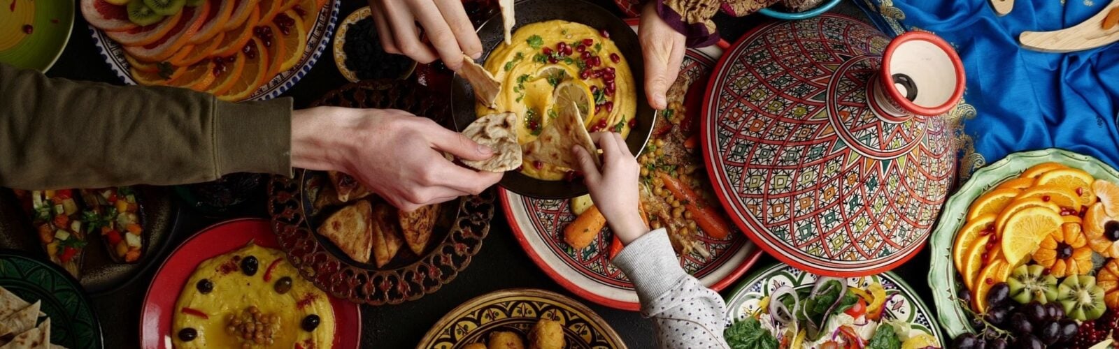 A family sharing a meal of typical Middle Eastern cuisine