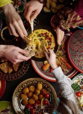 A family sharing a meal of typical Middle Eastern cuisine