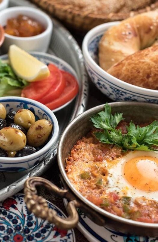 Traditional Turkish breakfast, featuring olives, eggs, and bread