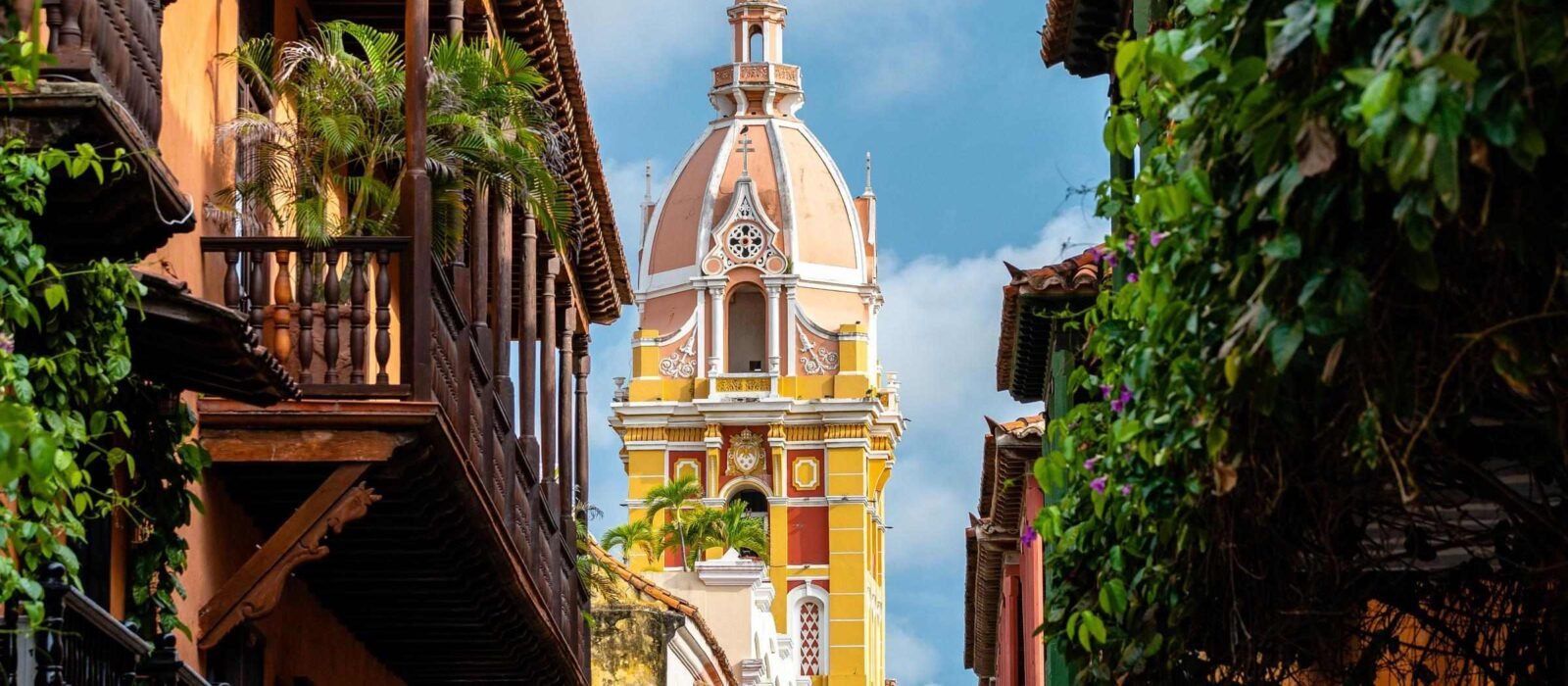 The tall yellow spire of a church in Cartagena, Colombia