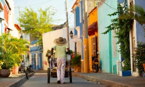 Man carrying a cart with fruit in a street of Cartagena, Colombia