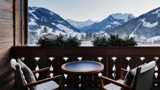 Two chairs on a terrace overlooking the mountains at The Alpina in Gstaad, Switzerland