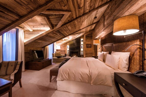 The bedroom of a suite at The Alpina in Gstaad, Switzerland