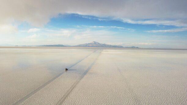 A 4x4 driving across the Salar de Uyuni slat flats in Bolivia