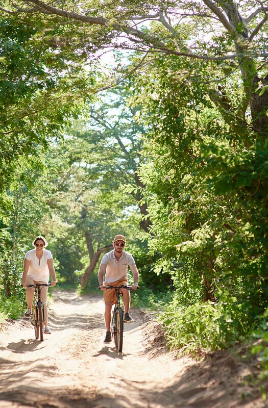 Cyclists at Chobe Chilwero camp in Chobe National Park, Botswana