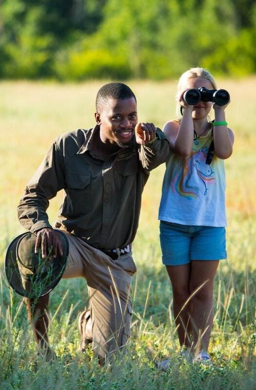 A child on a walking safari at Duba Plains Camp