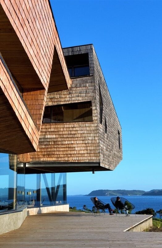 People relaxing by the water at Tierra Chiloe in Chile