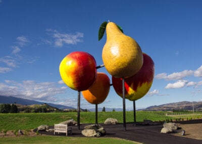 Logo featuring four giant fruit statues in Cromwell town in New Zealand