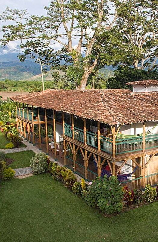 Hacienda Bambusa in Colombia, a luxurious hotel with a verandah and green balcony railings