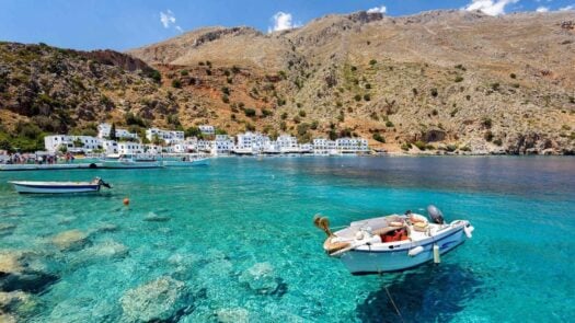 Small motorboat on the clear water in the bay of Loutro on Crete island, Greece