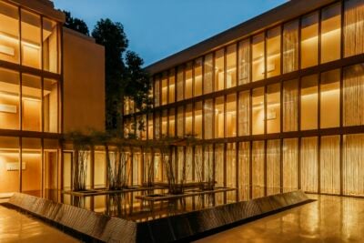 The reflection pond lit up at night at Six Senses Vana in India