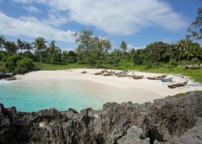 Boats anchor on the Mandorak Beach shoreline at Southwest Sumba, Indonesia