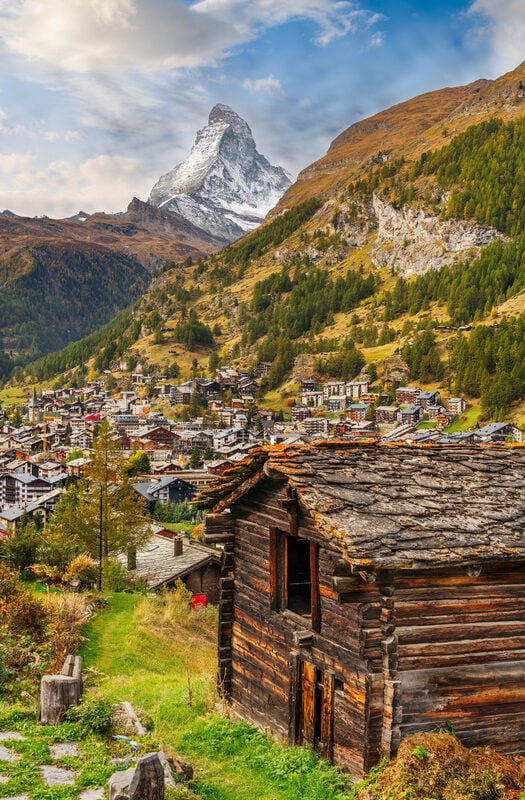 Old houses in Zermatt, Switzerland, with the Matterhorn in the distance