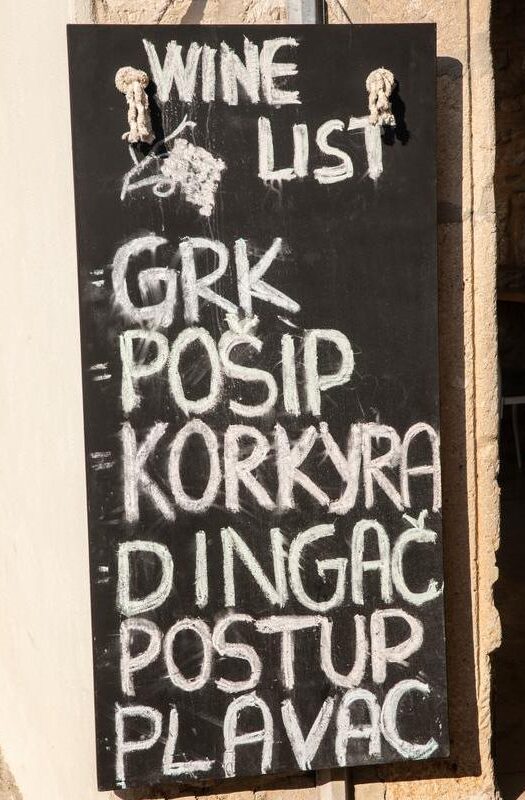 A sign board with different wines from the region of Korcula. Grk, Posip, Korokyra, Dingac, Postup