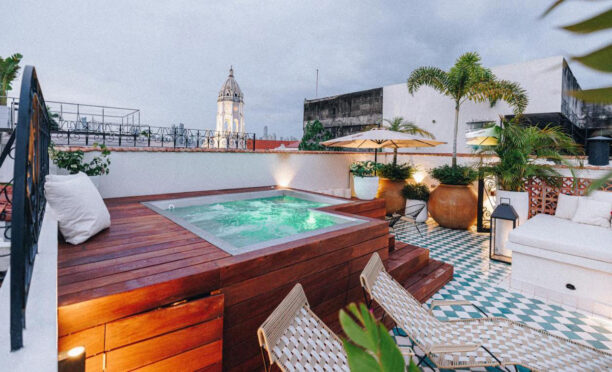 Rooftop terrace with hot tub and seating and view of Panama skyline