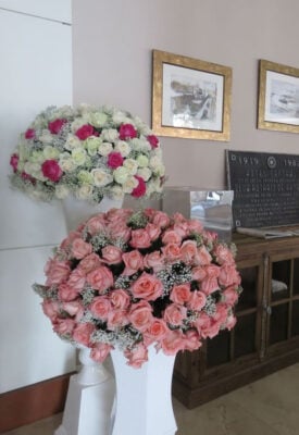 Floral arrangements of pink and white roses in a hotel lobby