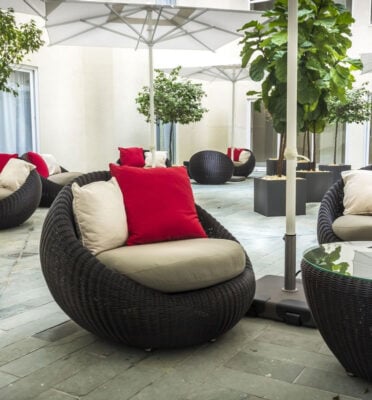 Outdoor circular seating with plush cushions under umbrellas at Central Hotel Panama