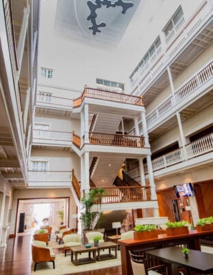 Interior view of Central hotel Panama lobby with tall staircase and seating area