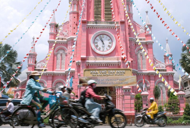 Pink Catholic Church and traffic in Ho Chi Minh City / Saigon, Vietnam