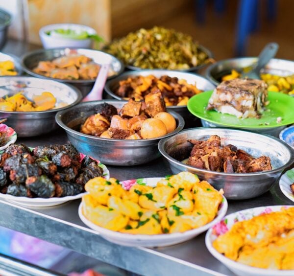 Assortment of Exotic grilled and baked asian food from meat in Hanoi in Vietnam. Street market with Vietnamese cuisine. Plates with food on display.