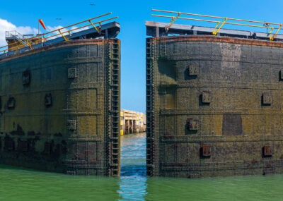 A huge metal lock gate swinging open on the Panama Canal