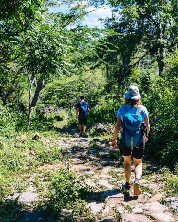 Two hikers on the ancient stone paved road from Barichara to Guane called 