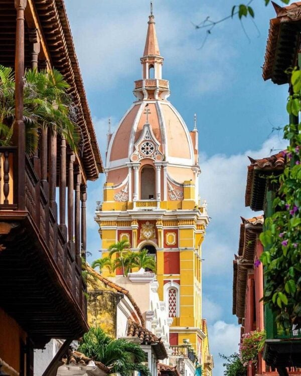 The tall yellow spire of a church in Cartagena, Colombia