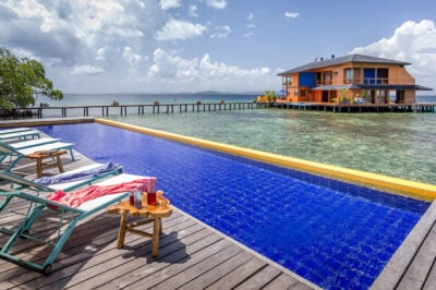 Outdoor pool next to ocean at Sweet Bocas private island resort, Panama