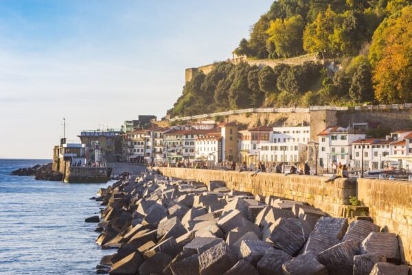 Rocks and white houses at the waterfront in San Sebastian, Spain