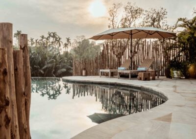 A private outdoor pool with sun loungers and a large parasol