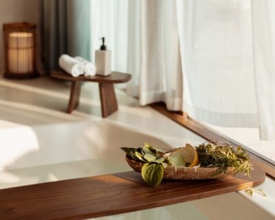 Close up of dried herbs on a wooden plank over a bath partially filled with water